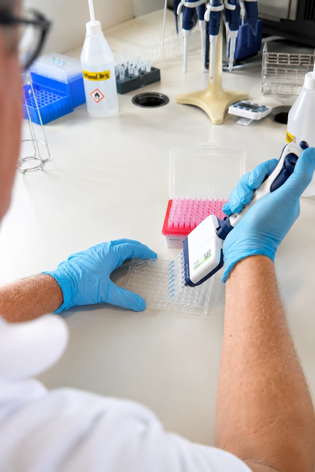 BioGntx researcher pipetting in the lab